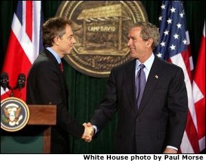 President George W. Bush and British Prime Minister Tony Blair shake hands after they conclude a joint news conference at the Camp David, March 27, 2003. "The United States and United Kingdom are acting together in a noble purpose. We're working together to make the world more peaceful; we're working together to make our respective nations and all the free nations of the world more secure; and we're working to free the Iraqi people," President Bush said. White House photo by Paul Morse